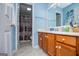 Bathroom with wood vanity, granite counters, and a shower/tub combo at 7358 S Mitchell Ct, Villa Rica, GA 30180