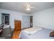 Bedroom with hardwood floors, a ceiling fan, and a large window providing natural light at 7358 S Mitchell Ct, Villa Rica, GA 30180