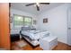 Bedroom with hardwood floors, a ceiling fan, and a window providing natural light at 7358 S Mitchell Ct, Villa Rica, GA 30180