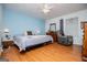 Bedroom with hardwood floors, a ceiling fan, and a large window providing natural light at 7358 S Mitchell Ct, Villa Rica, GA 30180