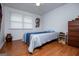 Bedroom with hardwood floors, a ceiling fan, and a large window providing natural light at 7358 S Mitchell Ct, Villa Rica, GA 30180