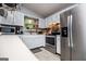 Well-lit kitchen featuring stainless steel appliances and white cabinets at 7358 S Mitchell Ct, Villa Rica, GA 30180