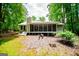 Charming home with a screened-in porch, surrounded by lush greenery, offers a peaceful retreat at 7358 S Mitchell Ct, Villa Rica, GA 30180