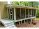 Exterior view of screened porch with comfortable seating and a hammock for enjoying the outdoors at 7358 S Mitchell Ct, Villa Rica, GA 30180
