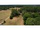 A large horse property features fenced pastures, mature trees, and a cozy home at 1024 Bethany Rd, Covington, GA 30016