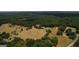 An expansive property has open fields, clusters of trees and neighboring homes nearby at 1024 Bethany Rd, Covington, GA 30016