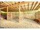 Interior of barn featuring wooden beams, hay-covered floor, and horse stalls at 1024 Bethany Rd, Covington, GA 30016