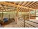 Barn interior with wooden beams, metal stalls, and hay-covered floor, creating a functional space at 1024 Bethany Rd, Covington, GA 30016