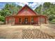 Barn featuring two garage doors, a covered porch, and a 'Welcome' sign, enhancing its welcoming appearance at 1024 Bethany Rd, Covington, GA 30016