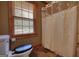 Bathroom featuring a toilet, shower with curtain, and natural light at 1024 Bethany Rd, Covington, GA 30016