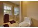 Bathroom with glass shower, tiled floors, and windows offering natural light at 1024 Bethany Rd, Covington, GA 30016
