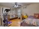 Cozy bedroom with ceiling fan, hardwood floors, and sewing machine table at 1024 Bethany Rd, Covington, GA 30016