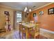 Open dining room featuring warm paint and a vintage chandelier at 1024 Bethany Rd, Covington, GA 30016