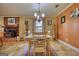 Bright dining room with a wood table, seating for six, adjacent to a brick fireplace at 1024 Bethany Rd, Covington, GA 30016