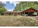 Brick home with large yard, firepit, covered carport, and mature landscaping at 1024 Bethany Rd, Covington, GA 30016