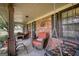 Inviting front porch boasts comfortable seating, complemented by brick detailing and a relaxing swing at 1024 Bethany Rd, Covington, GA 30016