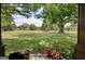 Serene view of the lush, expansive yard, framed by the porch and surrounding trees at 1024 Bethany Rd, Covington, GA 30016