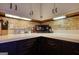 Compact kitchen featuring stone backsplash, stainless microwave, and ample countertop space at 1024 Bethany Rd, Covington, GA 30016