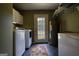 Laundry room with washer, dryer, water heater, and access door to the outdoors at 1024 Bethany Rd, Covington, GA 30016