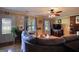 Cozy living room with large sofa, ceiling fan, brick fireplace, and an abundance of natural light at 1024 Bethany Rd, Covington, GA 30016