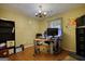Office space featuring hardwood floors, built-in shelving, and unique wagon wheel chandelier at 1024 Bethany Rd, Covington, GA 30016
