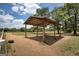 View of an outdoor shelter with wooden supports and a metal roof at 1024 Bethany Rd, Covington, GA 30016