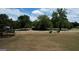 Scenic view of fenced pasture with horses grazing peacefully near mature trees and a charming country home at 1024 Bethany Rd, Covington, GA 30016