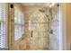 Tiled walk-in shower with rainfall shower head and glass enclosure at 1024 Bethany Rd, Covington, GA 30016