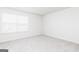 Bright bedroom with neutral carpet and a window with blinds at 319 Avondale Blvd, Conyers, GA 30013