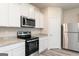 This kitchen features stainless steel appliances, granite countertops and white cabinetry at 319 Avondale Blvd, Conyers, GA 30013