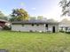 Backyard with grass, trees, and exterior view of the house at 51 Springside Se Dr, Atlanta, GA 30354