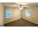 Bright bedroom featuring neutral paint, two windows and a ceiling fan at 51 Springside Se Dr, Atlanta, GA 30354