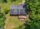 An overhead shot of the home with a spacious backyard, mature trees, and an outdoor deck at 1356 Lori Ct, Conley, GA 30288