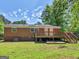 The backyard features a classic brick home with an outdoor deck and stairs at 1356 Lori Ct, Conley, GA 30288