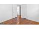 Neutral bedroom with hardwood floors leads to a laundry area at 1356 Lori Ct, Conley, GA 30288