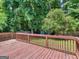 Spacious wooden deck perfect for outdoor entertaining and relaxation with its backyard and nature view at 1356 Lori Ct, Conley, GA 30288