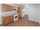 Efficient kitchen with white appliances, wood cabinets, and a light countertop, ready for immediate use at 1356 Lori Ct, Conley, GA 30288