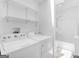 Laundry room with washer, dryer, shelves and full bath at 1356 Lori Ct, Conley, GA 30288
