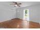 Sunny living room with hardwood floors, ceiling fan, and a view to the beautiful green exterior at 1356 Lori Ct, Conley, GA 30288