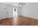 Bright living room with hardwood floors, ceiling fan, and a door leading to a verdant outdoor view at 1356 Lori Ct, Conley, GA 30288