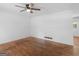 Bright living room with hardwood floors, a ceiling fan, and neutral walls, ideal for customization at 1356 Lori Ct, Conley, GA 30288