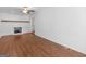 Cozy living room features a brick fireplace, wood floors, and a ceiling fan at 1356 Lori Ct, Conley, GA 30288