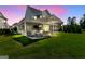 Backyard patio with ample seating, large umbrella, and an outdoor kitchen area in a well-manicured lawn at 229 Widener Way, Peachtree City, GA 30269