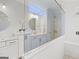 Bright bathroom features a double vanity with marble countertops, modern fixtures and a frameless shower at 229 Widener Way, Peachtree City, GA 30269