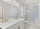 Bathroom featuring a vanity with double sinks, toilet, and a shower with white subway tile at 229 Widener Way, Peachtree City, GA 30269