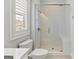 Bathroom view showcasing a glass shower, toilet, window, and white subway tile at 229 Widener Way, Peachtree City, GA 30269