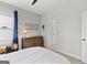Bright bedroom with a light gray wall, a wood dresser, and a plush, soft carpet at 229 Widener Way, Peachtree City, GA 30269