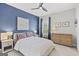 Cozy bedroom featuring a blue accent wall, ceiling fan, and neutral furniture at 229 Widener Way, Peachtree City, GA 30269