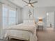 Cozy bedroom with a ceiling fan, white shutters, and an ensuite bathroom at 229 Widener Way, Peachtree City, GA 30269