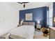 Cozy bedroom featuring a blue accent wall, ceiling fan, and neutral furniture at 229 Widener Way, Peachtree City, GA 30269